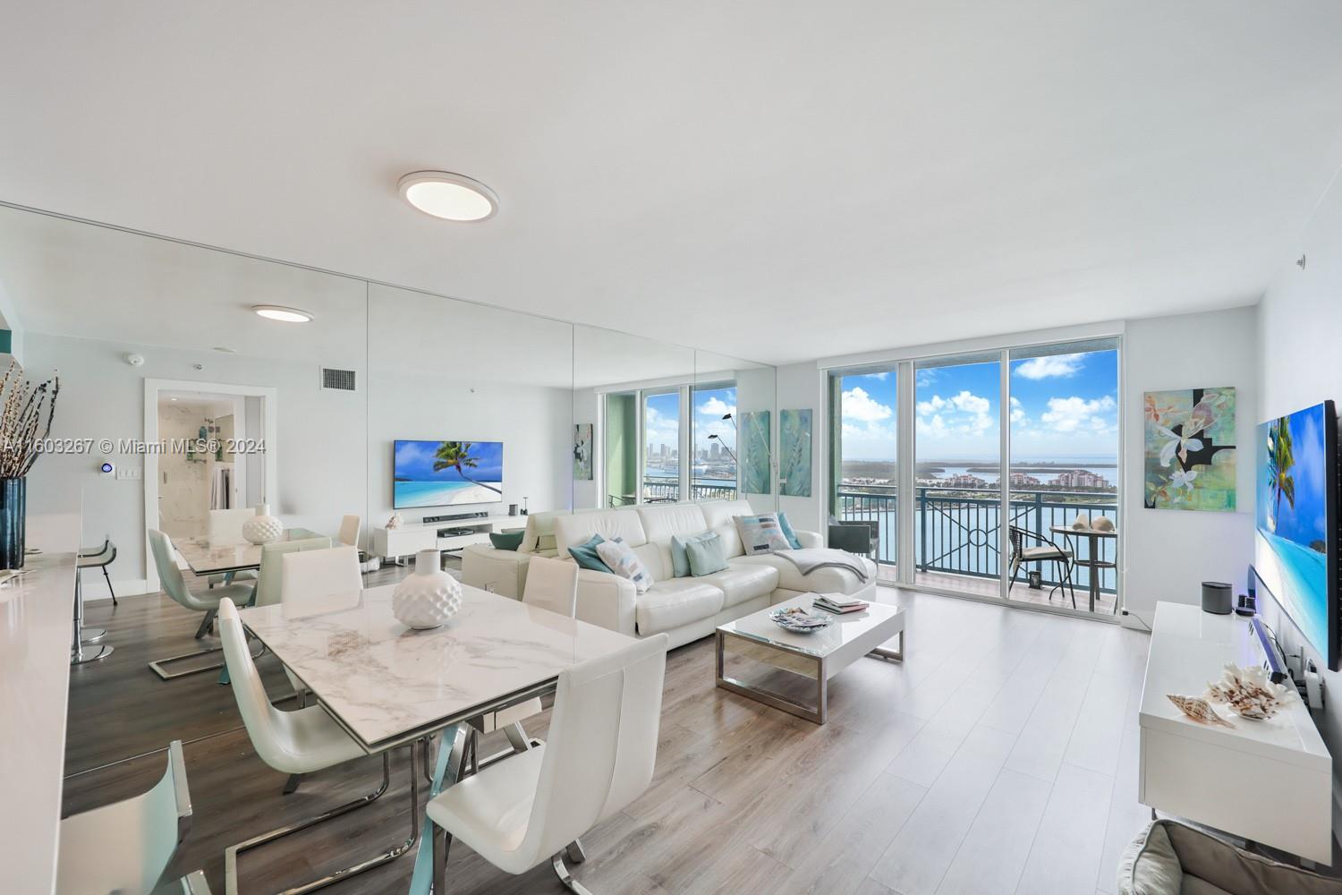 90 Alton Road, Unit 2806 Miami Beach, FL 33139 - Photo 14 of 36 a living room with furniture and a large window