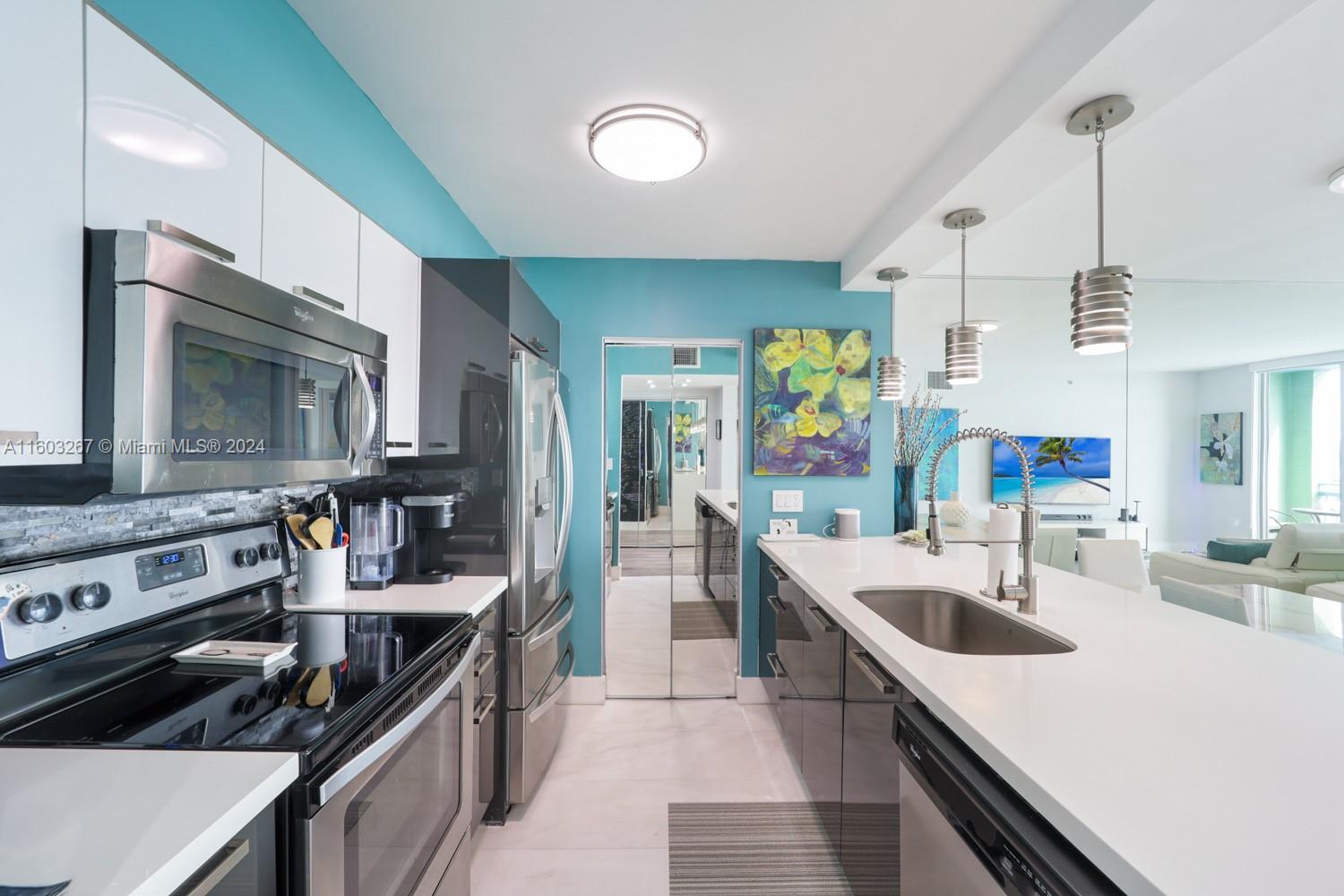 90 Alton Road, Unit 2806 Miami Beach, FL 33139 - Photo 15 of 36 a kitchen with stainless steel appliances granite countertop a sink and a stove