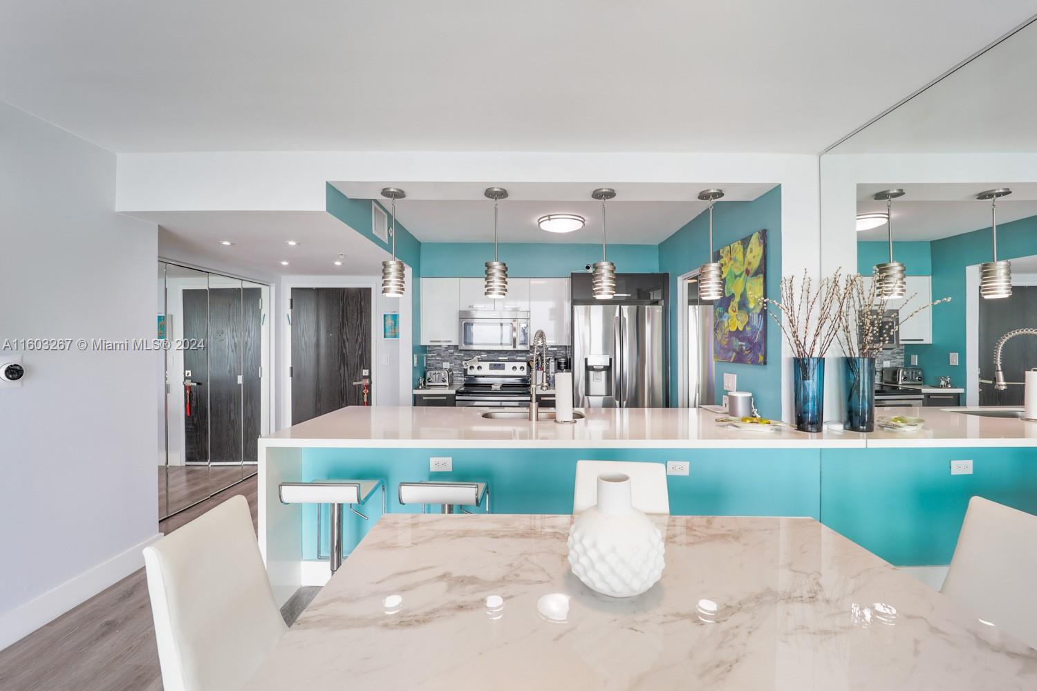 90 Alton Road, Unit 2806 Miami Beach, FL 33139 - Photo 3 of 36 a large white kitchen with a large window