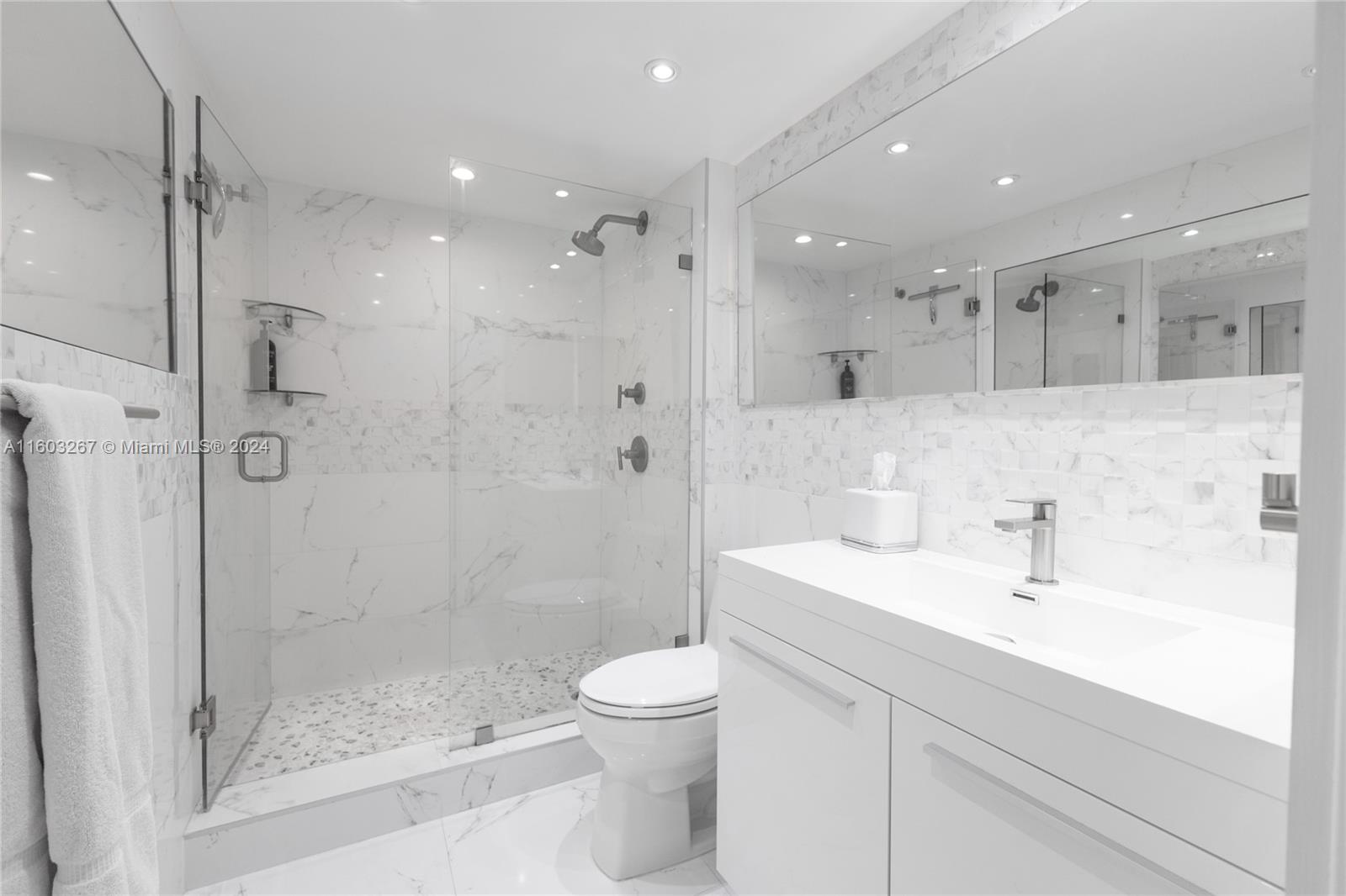 90 Alton Road, Unit 2806 Miami Beach, FL 33139 - Photo 6 of 36 a bathroom with a sink a toilet and shower