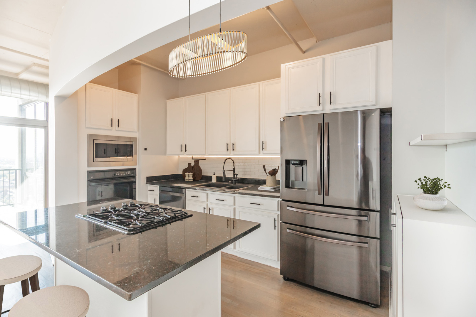 1530 South State Street, Unit 14O Chicago, IL 60605 - Photo 5 of 20 a kitchen with stainless steel appliances granite countertop a stove refrigerator sink and cabinets