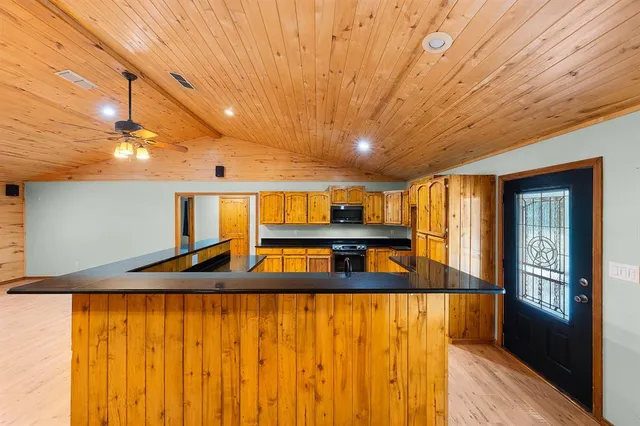 a view of a room with wooden floor