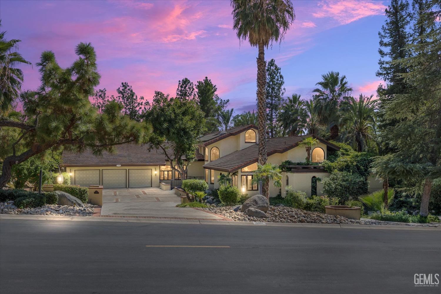 Undisclosed Address Bakersfield, CA 93306 - Photo 1 of 75 a front view of a house with a street and trees