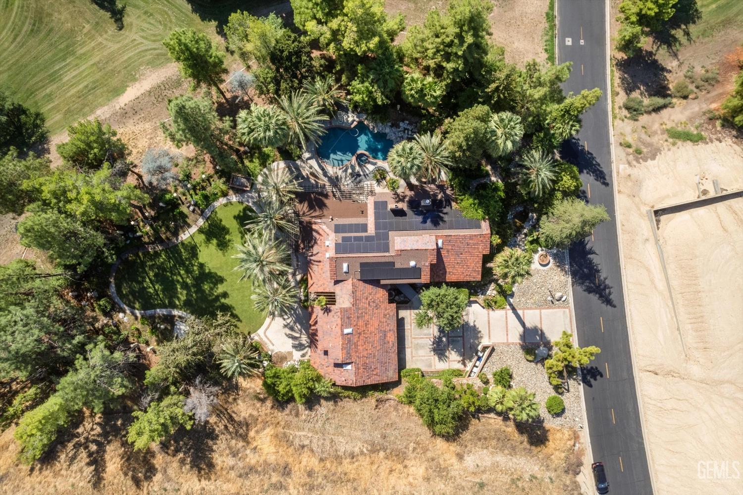 Undisclosed Address Bakersfield, CA 93306 - Photo 11 of 75 an aerial view of a house with a yard and garden