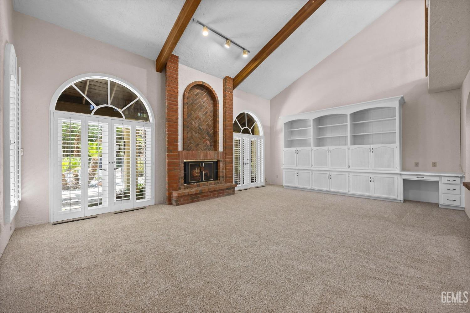 Undisclosed Address Bakersfield, CA 93306 - Photo 17 of 75 a view of an empty room with a fireplace and a large window