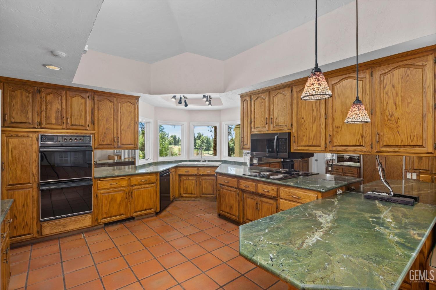 Undisclosed Address Bakersfield, CA 93306 - Photo 21 of 75 a kitchen with stainless steel appliances granite countertop a sink counter space cabinets and a stove