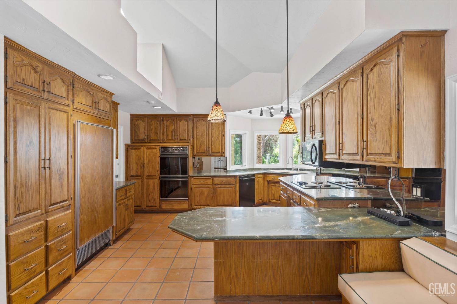 Undisclosed Address Bakersfield, CA 93306 - Photo 22 of 75 a kitchen with stainless steel appliances granite countertop a sink a stove and a refrigerator