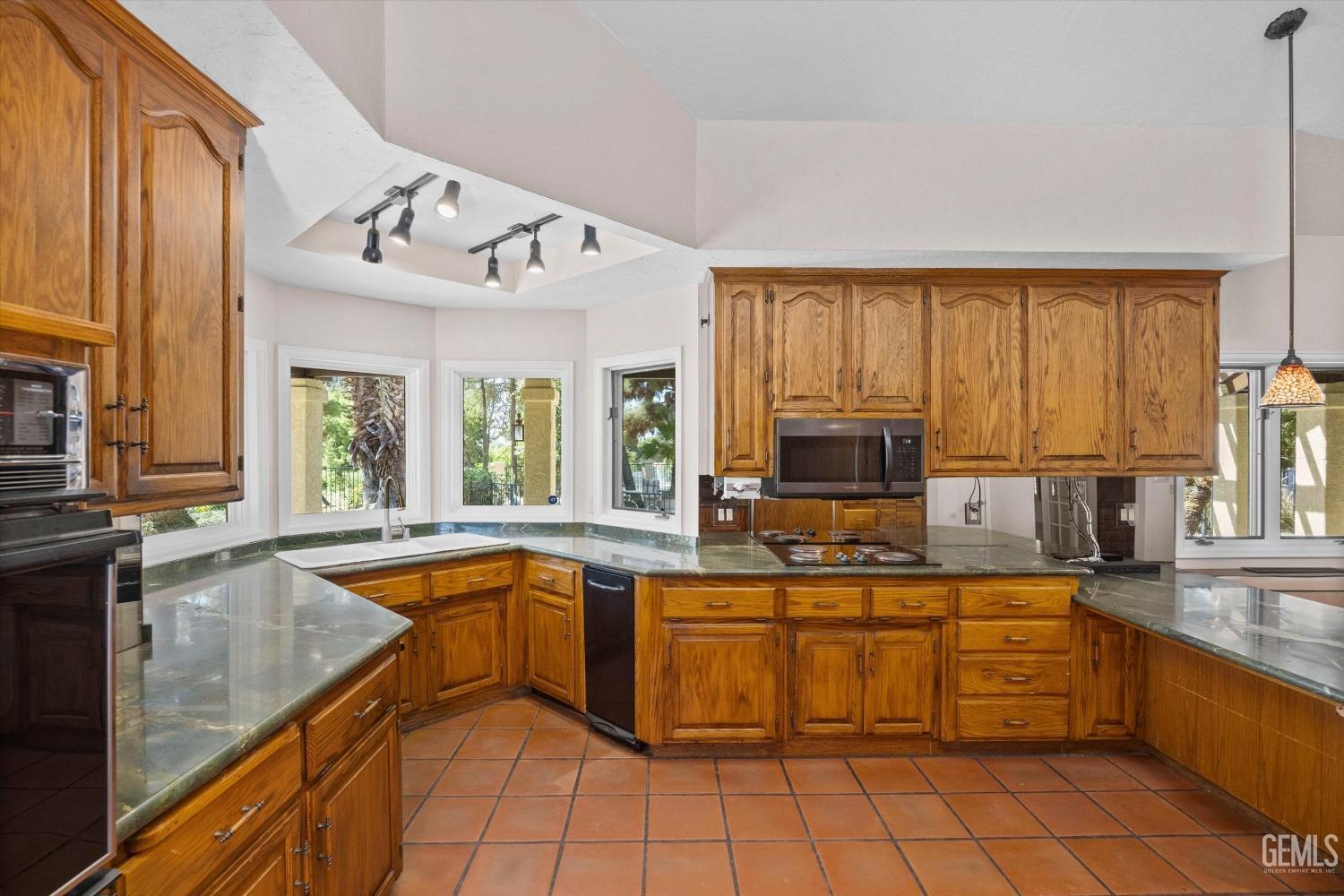 Undisclosed Address Bakersfield, CA 93306 - Photo 23 of 75 a kitchen with stainless steel appliances granite countertop a sink and cabinets