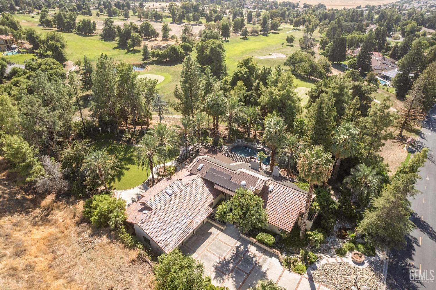 Undisclosed Address Bakersfield, CA 93306 - Photo 3 of 75 an aerial view of residential house with swimming pool and green space
