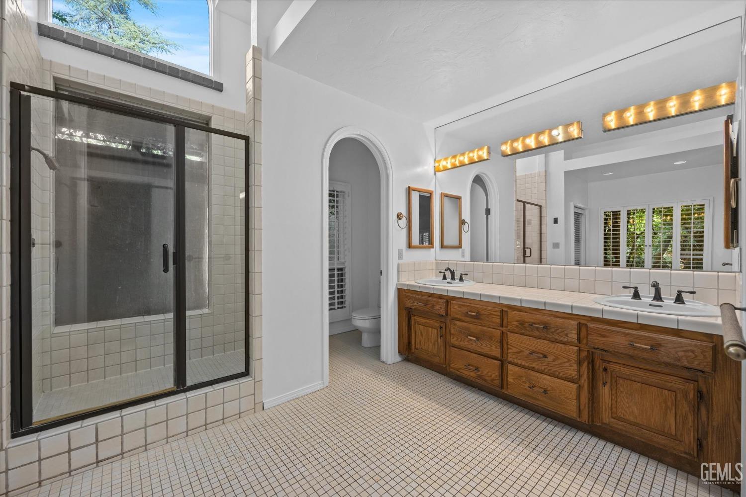 Undisclosed Address Bakersfield, CA 93306 - Photo 32 of 75 a bathroom with a double vanity sink and a mirror