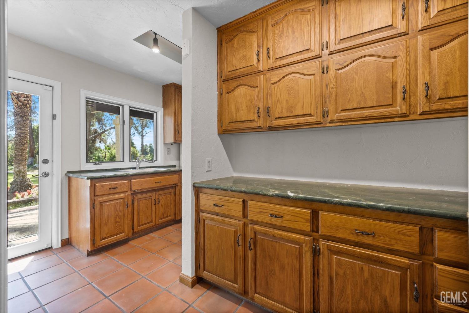 Undisclosed Address Bakersfield, CA 93306 - Photo 38 of 75 a kitchen with stainless steel appliances granite countertop a refrigerator and cabinets