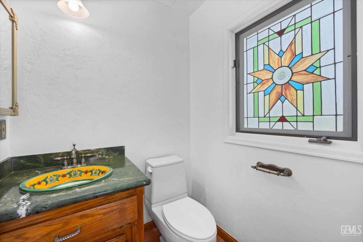 Undisclosed Address Bakersfield, CA 93306 - Photo 40 of 75 a bathroom with a stove a sink and a mirror