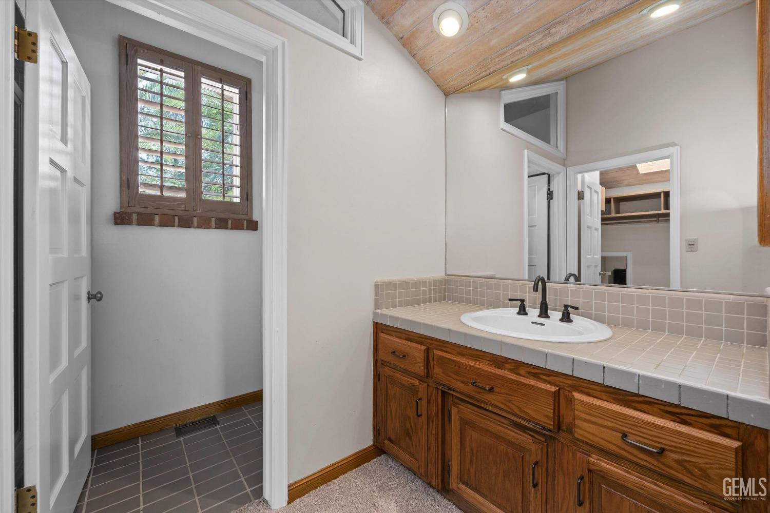 Undisclosed Address Bakersfield, CA 93306 - Photo 53 of 75 a bathroom with a sink and a mirror