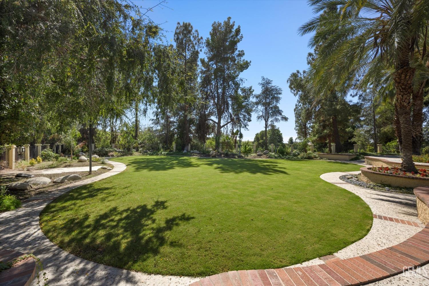 Undisclosed Address Bakersfield, CA 93306 - Photo 63 of 75 a view of a swimming pool with a yard and trees