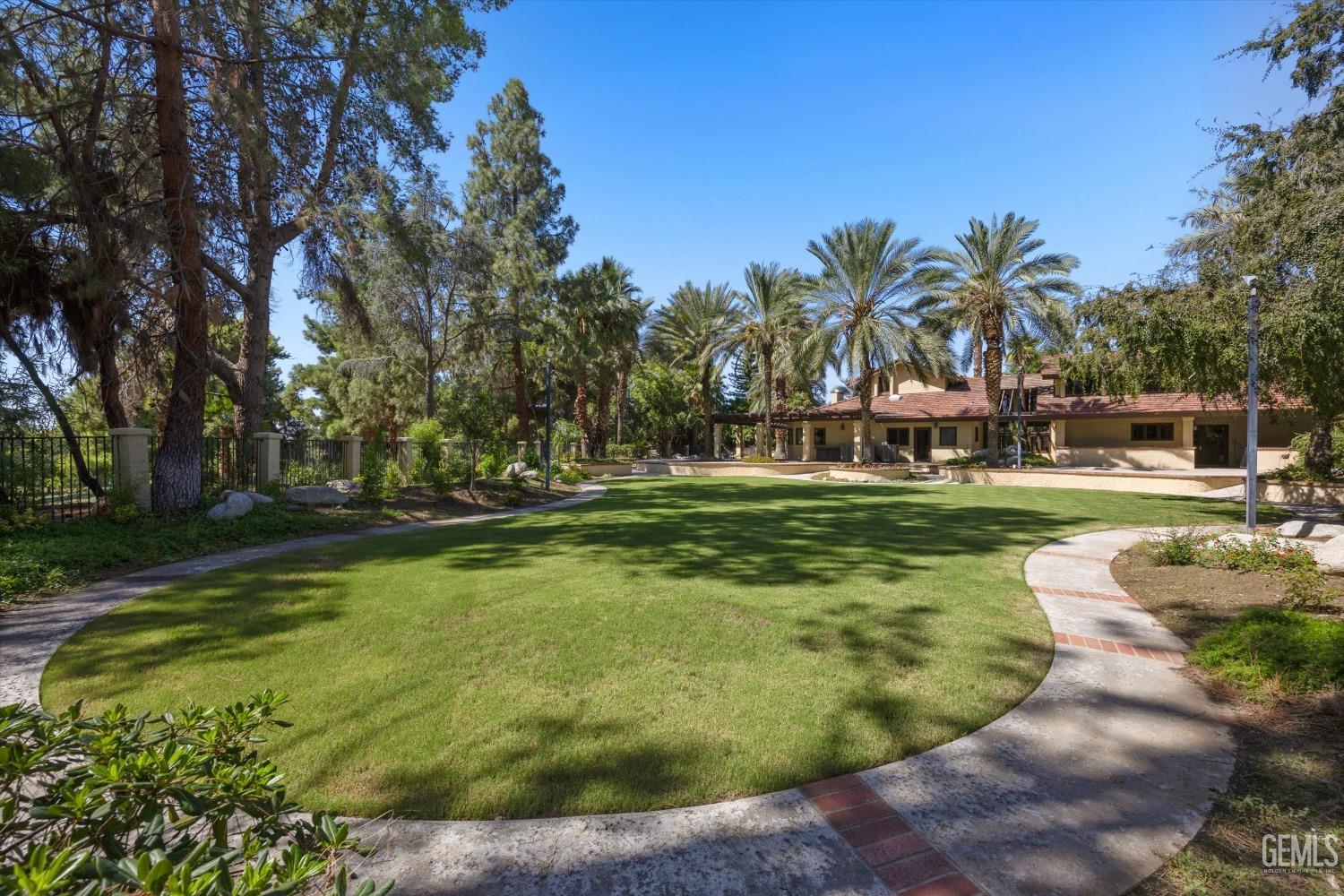 Undisclosed Address Bakersfield, CA 93306 - Photo 66 of 75 a view of a swimming pool with a garden