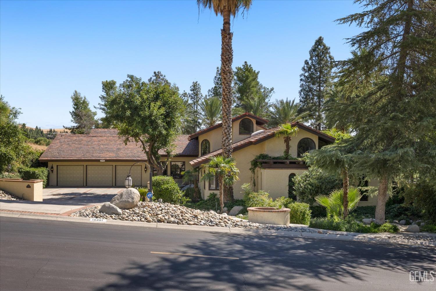 Undisclosed Address Bakersfield, CA 93306 - Photo 7 of 75 a front view of a house with a yard and garage