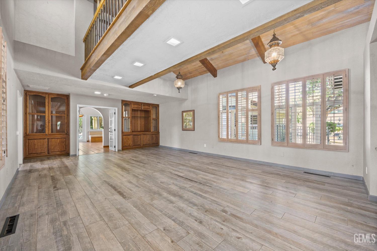 Undisclosed Address Bakersfield, CA 93306 - Photo 74 of 75 a view of an empty room with wooden floor and a window