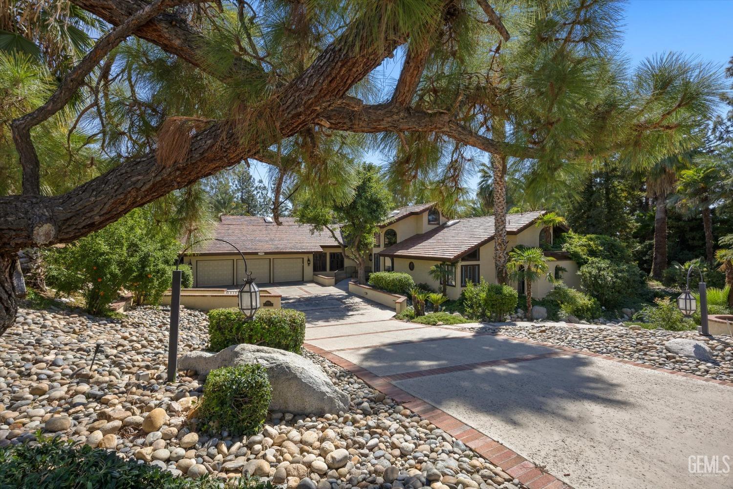 Undisclosed Address Bakersfield, CA 93306 - Photo 8 of 75 a view of a street with a tree