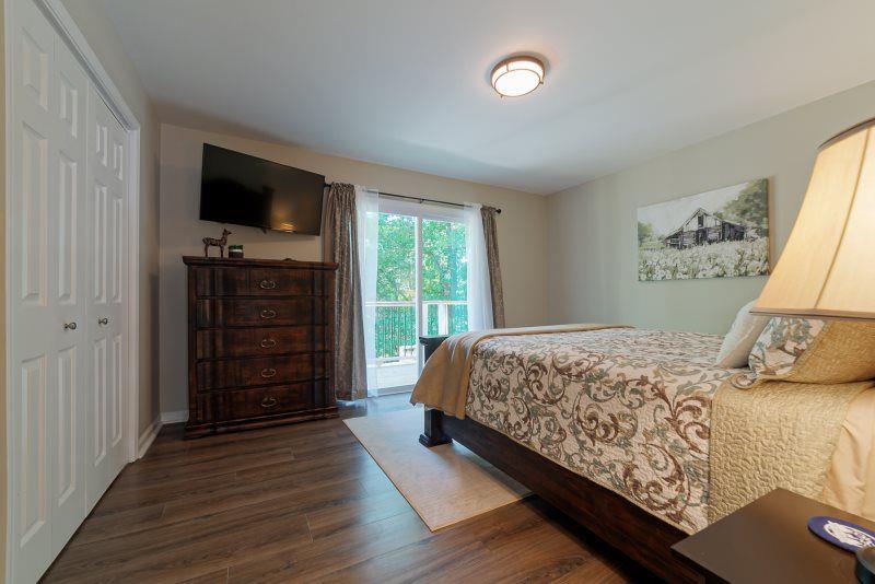 39 Schwarzwald Strasse Helen, GA 30545 - Photo 13 of 25 a bedroom with a bed and flat screen tv