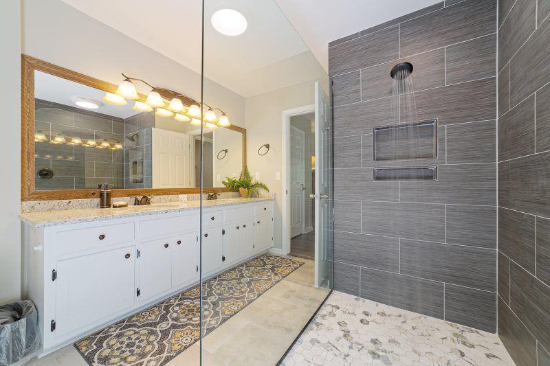 39 Schwarzwald Strasse Helen, GA 30545 - Photo 8 of 25 a bathroom with a double vanity sink a toilet a mirror and shower