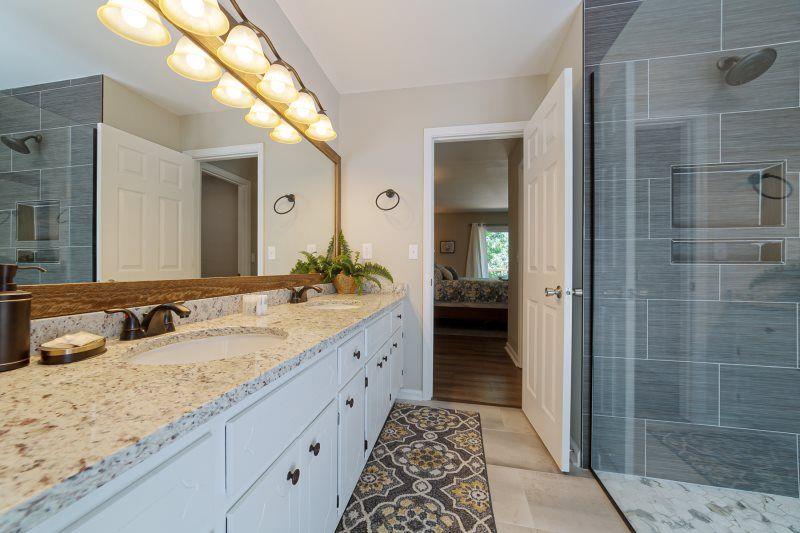 39 Schwarzwald Strasse Helen, GA 30545 - Photo 9 of 25 a bathroom with a granite countertop sink and a mirror