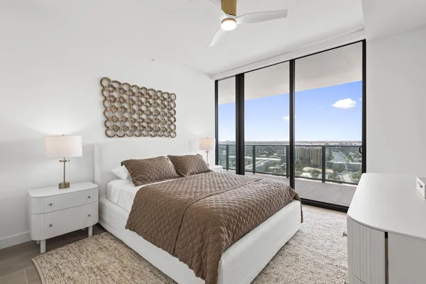 a bedroom with a large bed and a window