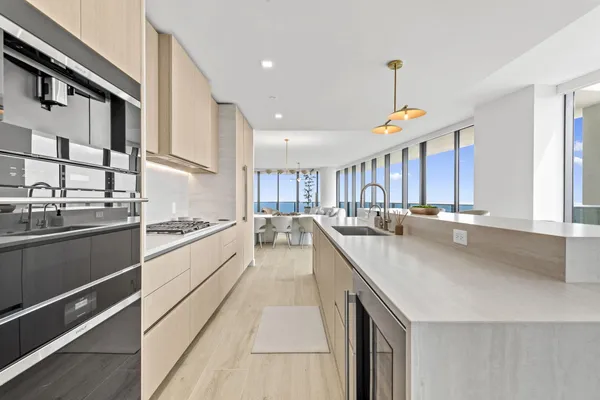 a large kitchen with stainless steel appliances lots of counter space and a sink