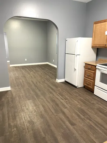 a kitchen with a refrigerator and a stove