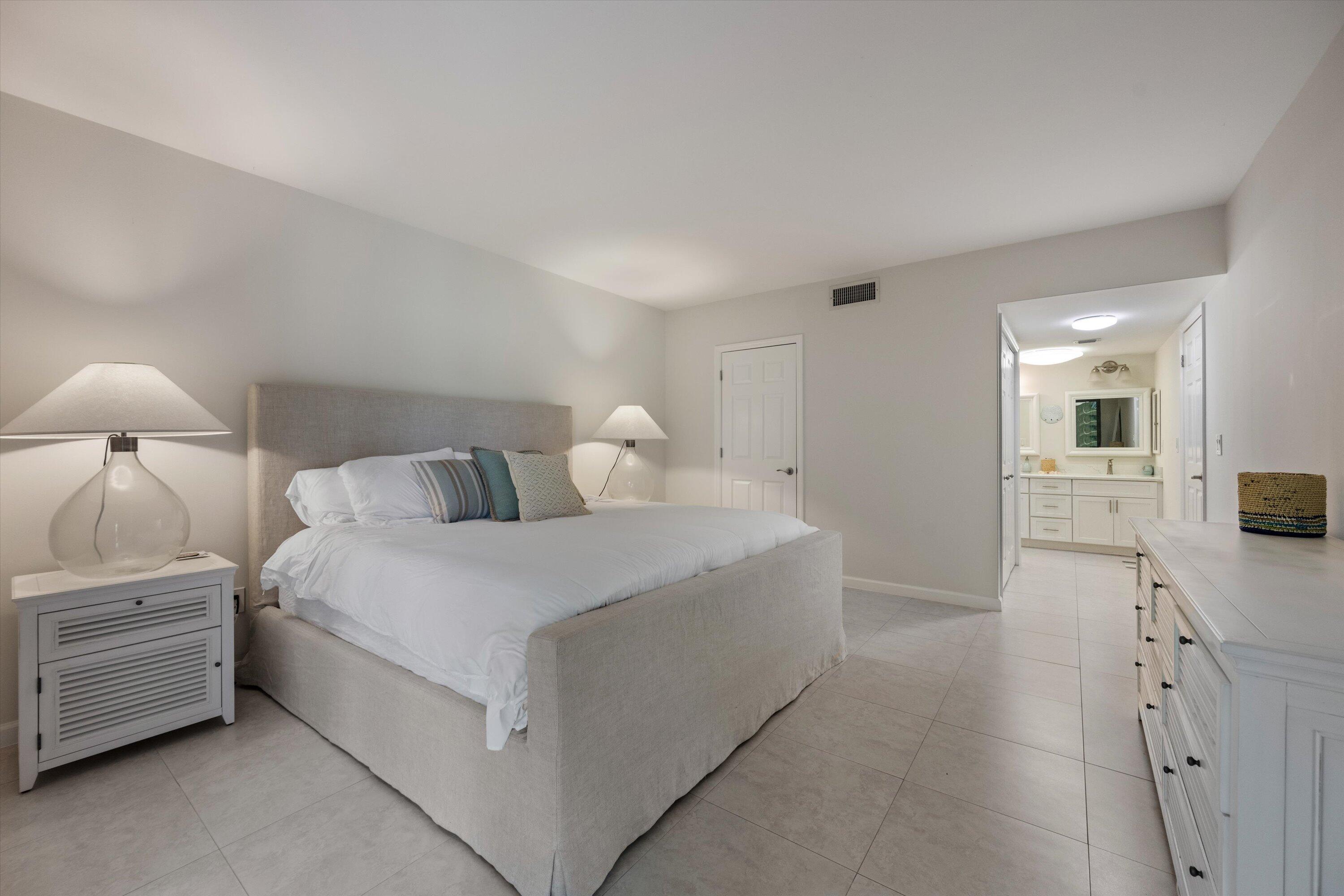 13334 Polo Club Road, Unit 228 Wellington, FL 33414 - Photo 13 of 26 a bedroom with a bed and a view of bathroom