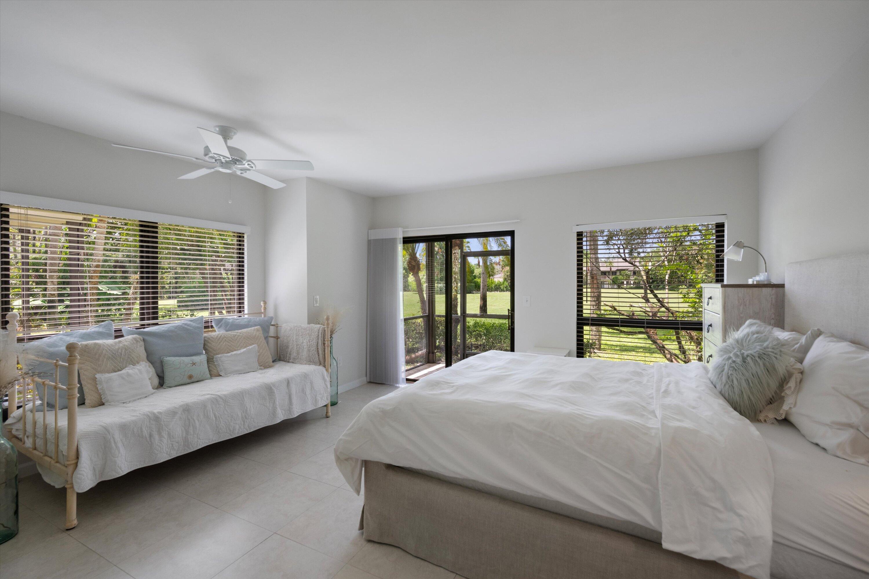 13334 Polo Club Road, Unit 228 Wellington, FL 33414 - Photo 16 of 26 a bedroom with a bed and a couch