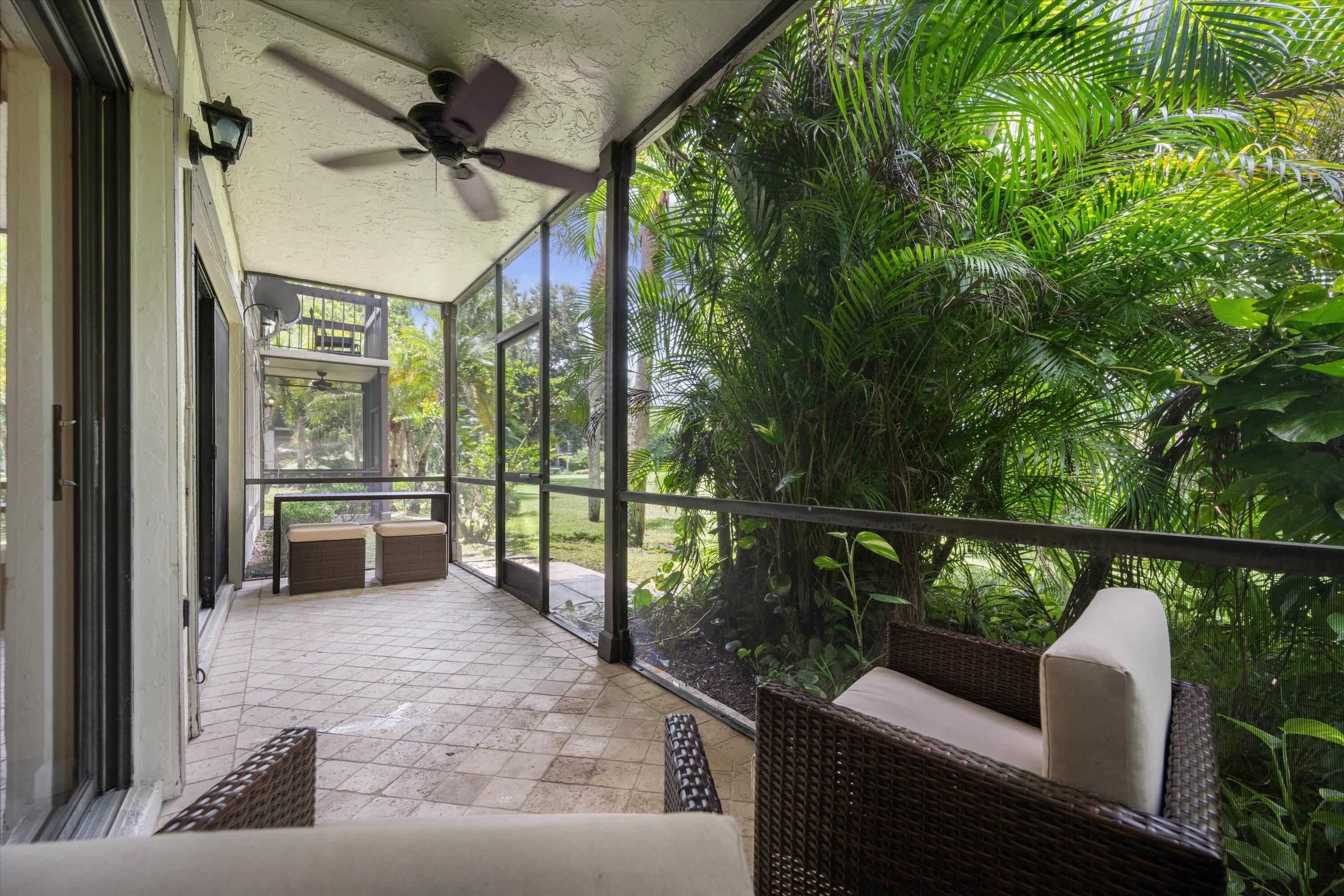 13334 Polo Club Road, Unit 228 Wellington, FL 33414 - Photo 22 of 26 a balcony with wooden floor and outdoor seating