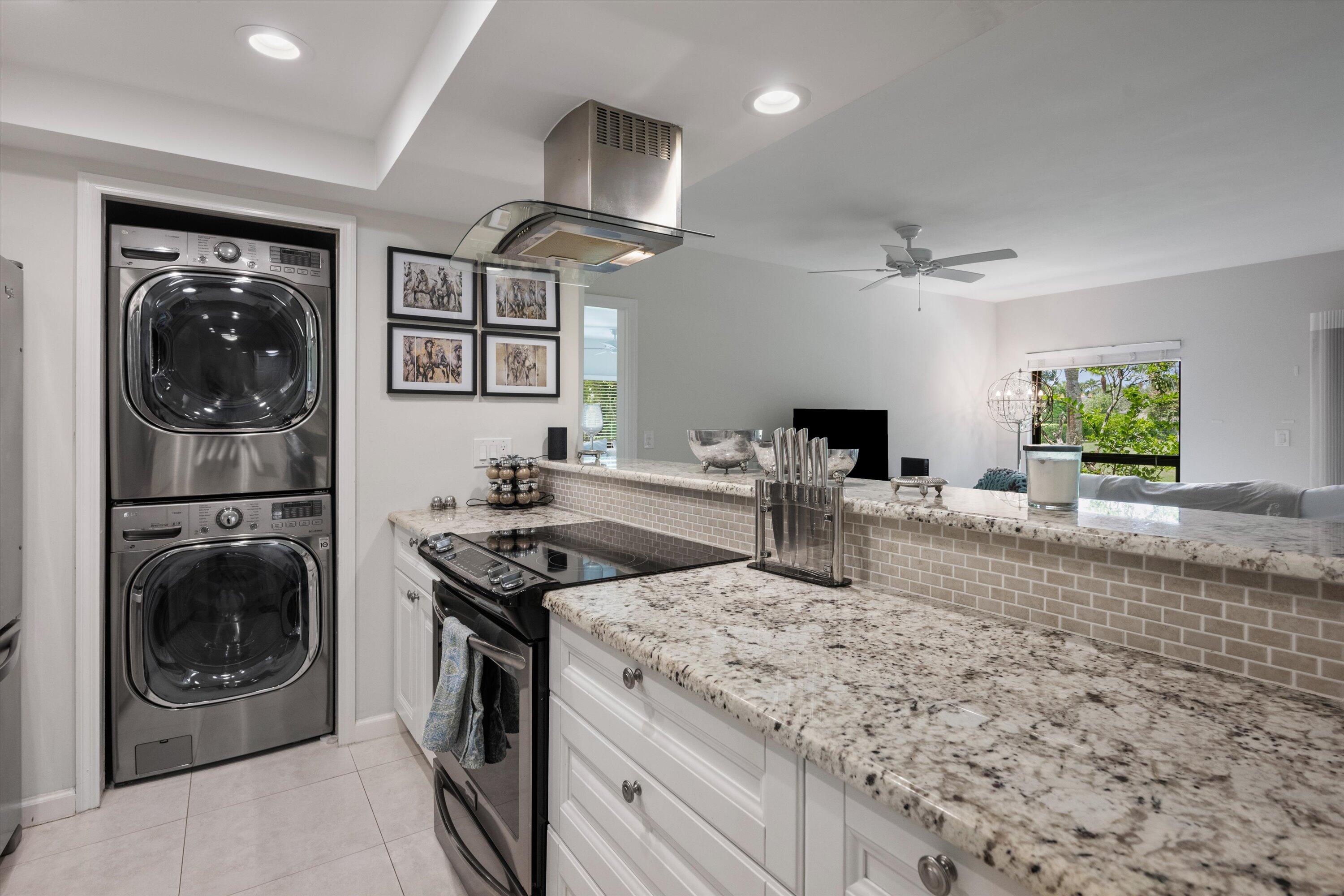 13334 Polo Club Road, Unit 228 Wellington, FL 33414 - Photo 10 of 26 a kitchen with stainless steel appliances granite countertop a stove a sink and a refrigerator