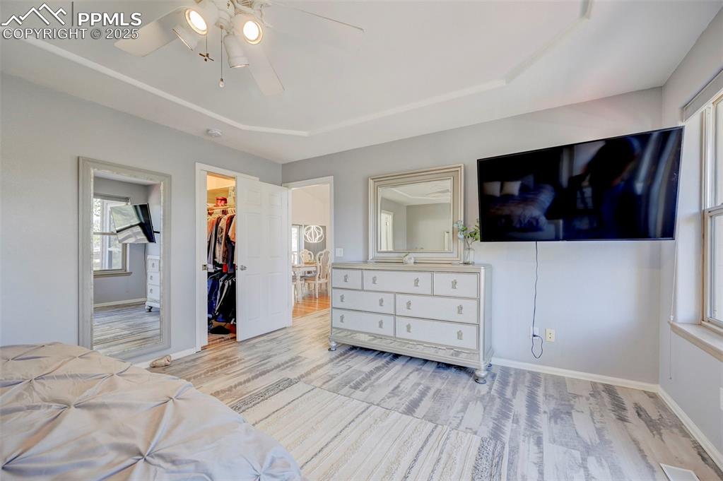 840 West Kelly Road Woodland Park, CO 80863 - Photo 13 of 47 Bedroom with light wood finished floors, baseboards, a closet, and a walk in closet