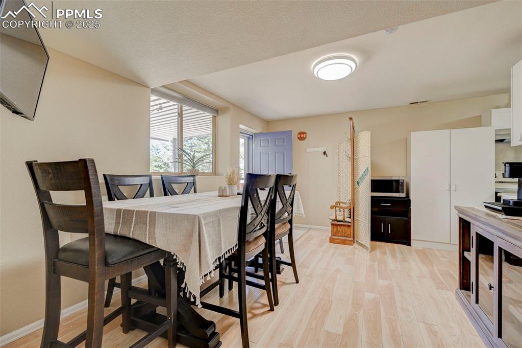 840 West Kelly Road Woodland Park, CO 80863 - Photo 27 of 47 Dining space with baseboards and light wood-type flooring