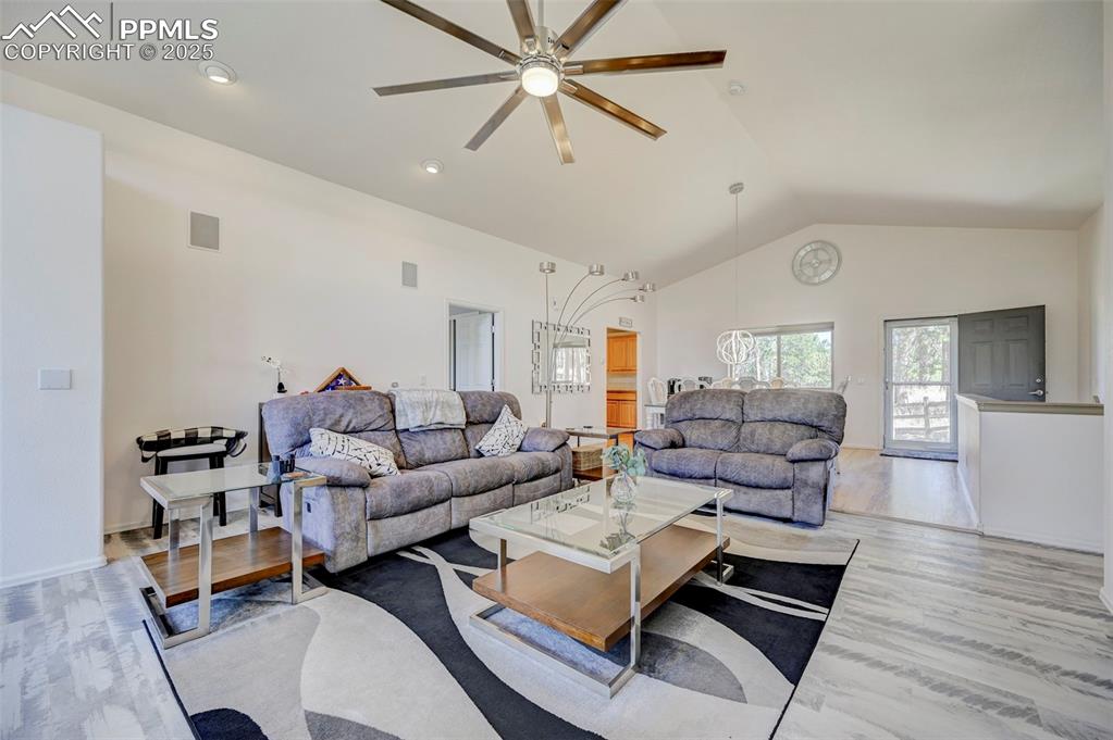 840 West Kelly Road Woodland Park, CO 80863 - Photo 3 of 47 Living room with light wood finished floors, vaulted ceiling, visible vents, and a ceiling fan