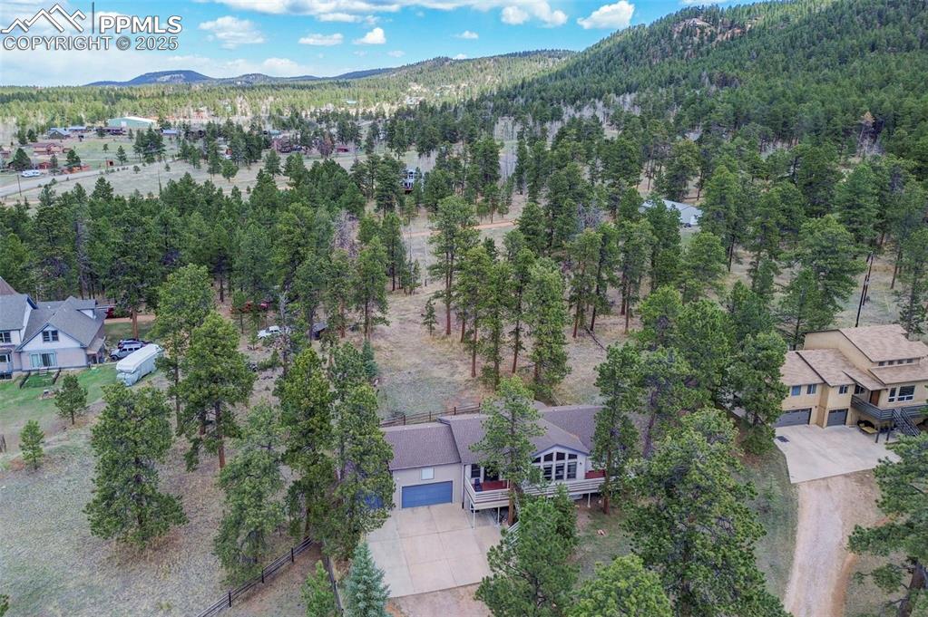 840 West Kelly Road Woodland Park, CO 80863 - Photo 41 of 47 Drone / aerial view featuring a forest view and a mountain view