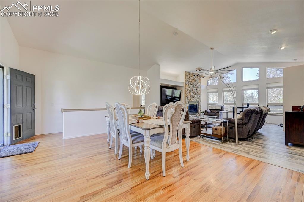 840 West Kelly Road Woodland Park, CO 80863 - Photo 7 of 47 Dining room featuring ceiling fan, lofted ceiling, light wood-style floors, and baseboards
