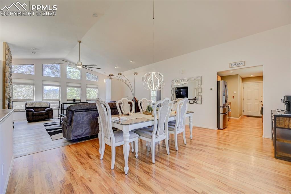 840 West Kelly Road Woodland Park, CO 80863 - Photo 8 of 47 Dining room featuring light wood finished floors, vaulted ceiling, and ceiling fan