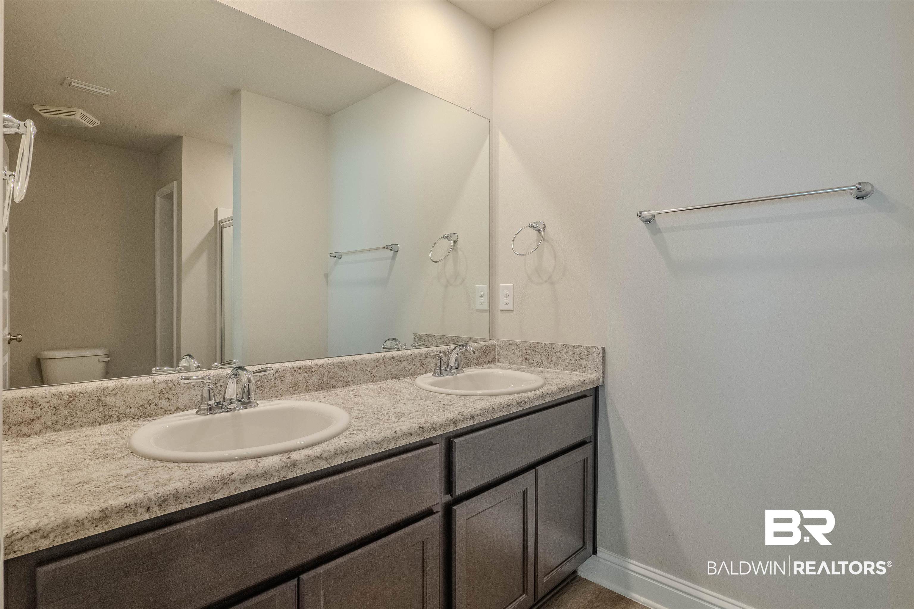 25806 Pollard Road, Unit 32 Daphne, AL 36526 - Photo 13 of 23 Bathroom featuring vanity and toilet