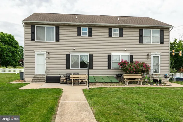 a front view of a house with a garden