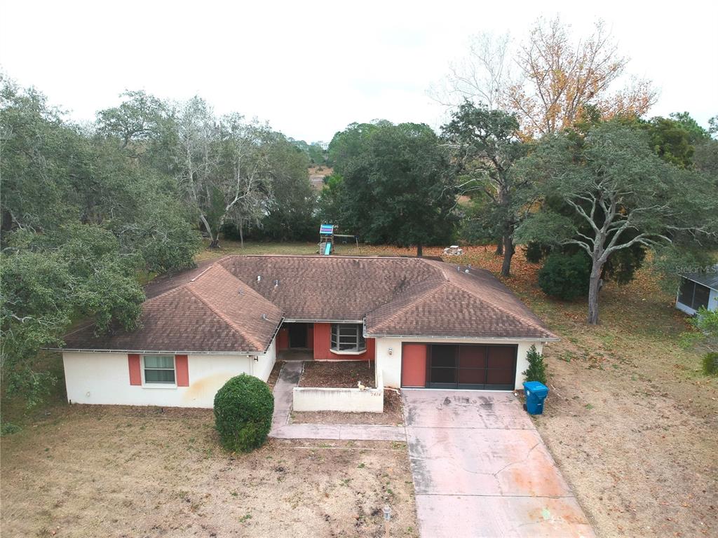 7414 Acorn Circle Spring Hill, FL 34606 - Photo 1 of 50 an aerial view of a house with a yard