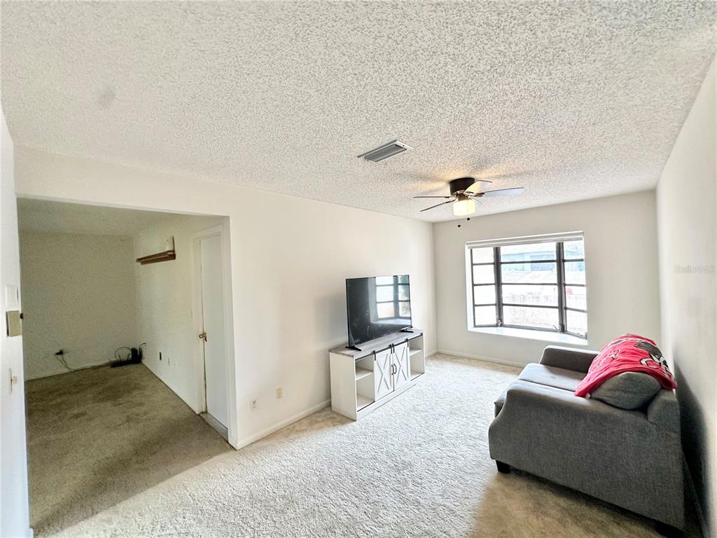 7414 Acorn Circle Spring Hill, FL 34606 - Photo 11 of 50 a living room with furniture window and flat screen tv