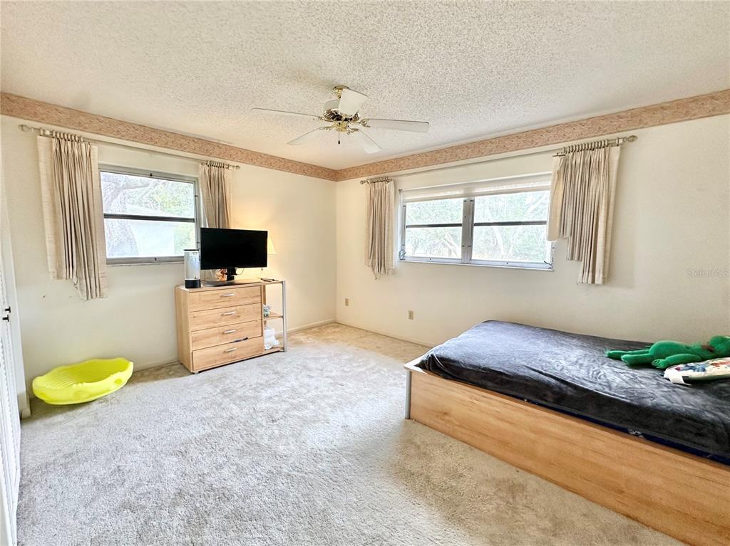 7414 Acorn Circle Spring Hill, FL 34606 - Photo 22 of 50 a living room with furniture and a flat screen tv
