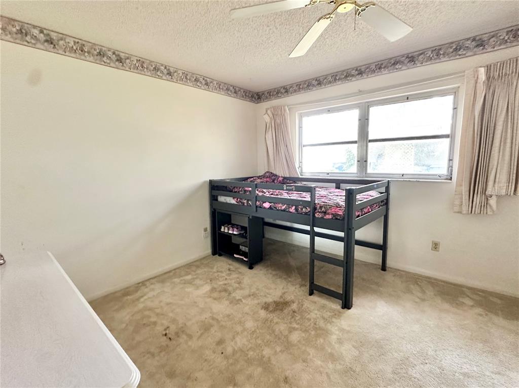 7414 Acorn Circle Spring Hill, FL 34606 - Photo 25 of 50 a room with furniture and window