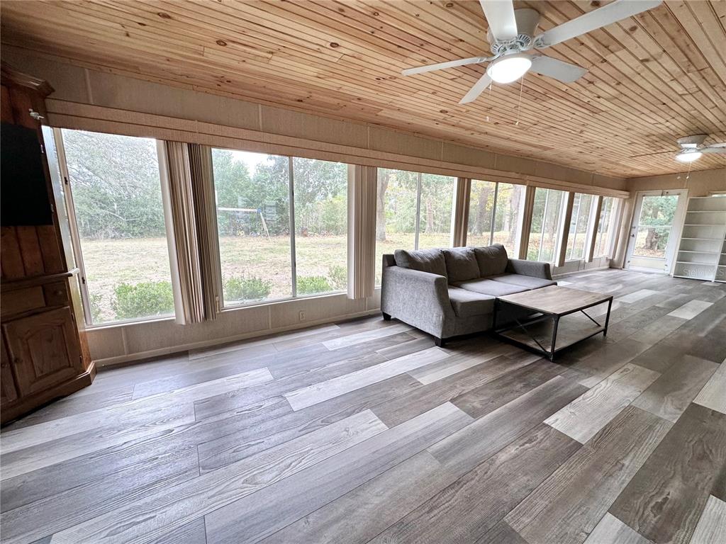 7414 Acorn Circle Spring Hill, FL 34606 - Photo 33 of 50 a living room with furniture and a large window