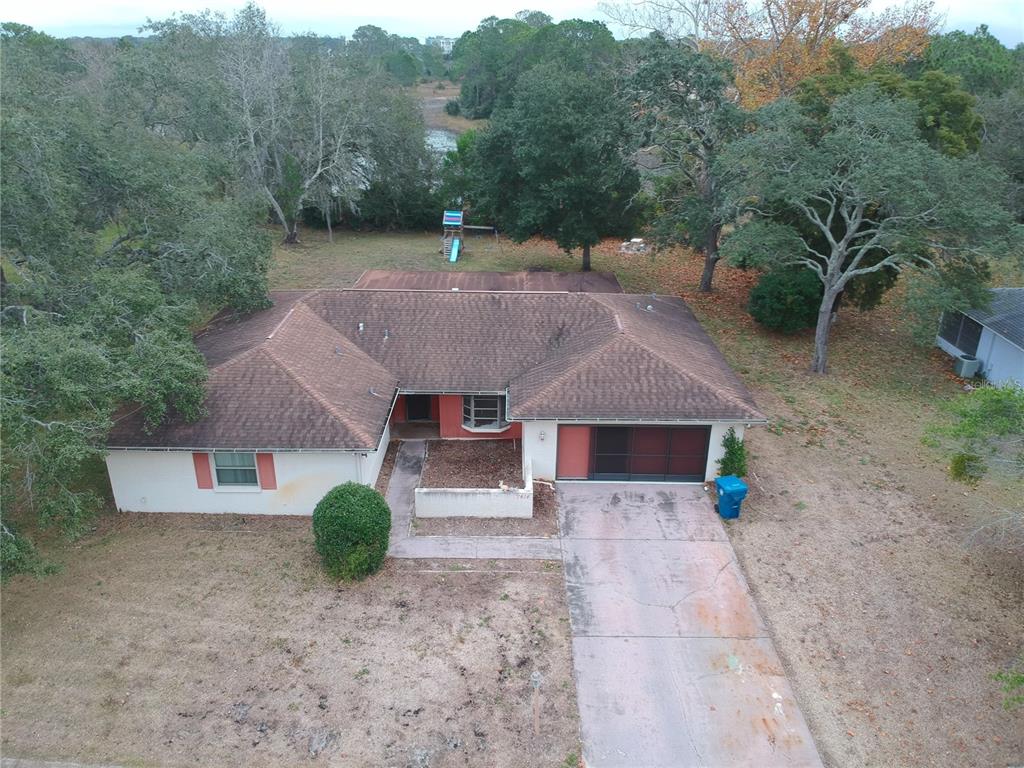 7414 Acorn Circle Spring Hill, FL 34606 - Photo 49 of 50 a front view of a house with a yard and garage
