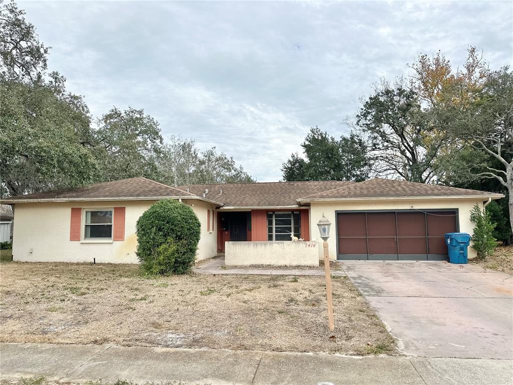 7414 Acorn Circle Spring Hill, FL 34606 - Photo 50 of 50 front view of a house with a yard