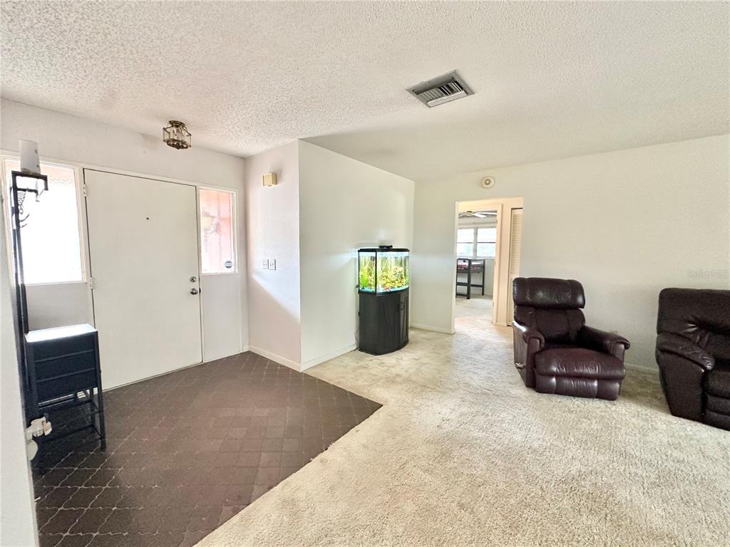 7414 Acorn Circle Spring Hill, FL 34606 - Photo 7 of 50 a living room with furniture and a closet