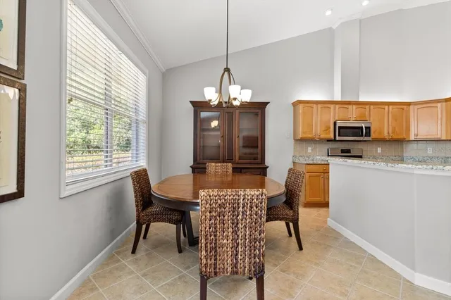 a kitchen with granite countertop a stove and a microwave