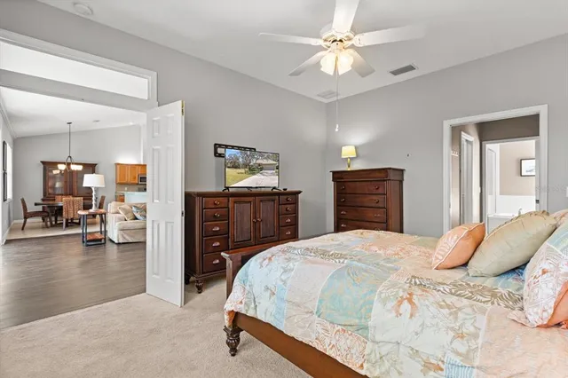 a bedroom with a bed and a ceiling fan